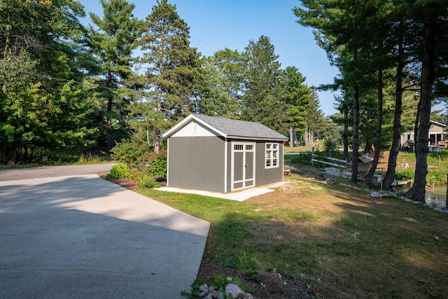 view of outbuilding featuring a lawn