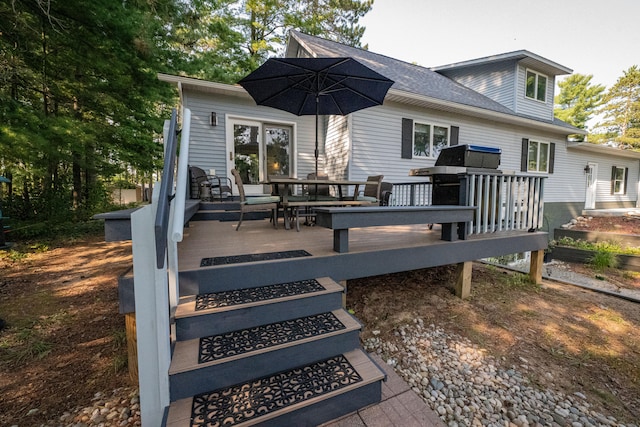 rear view of property with a wooden deck