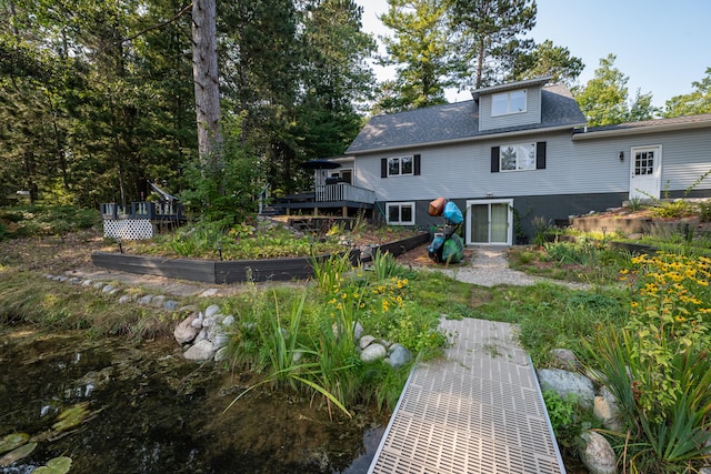 rear view of house featuring a deck