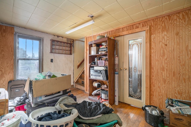 misc room featuring wood walls and light hardwood / wood-style floors