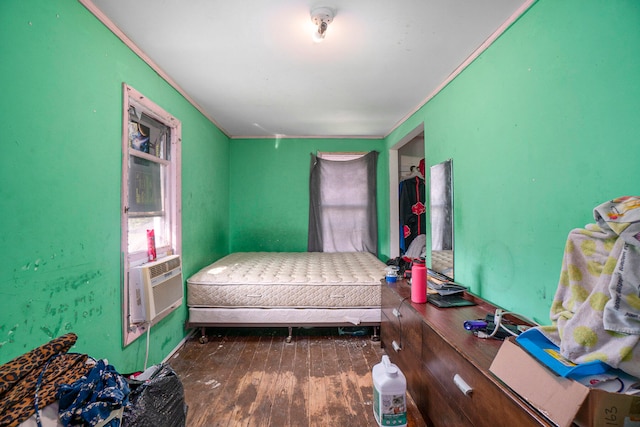 bedroom with cooling unit and hardwood / wood-style floors