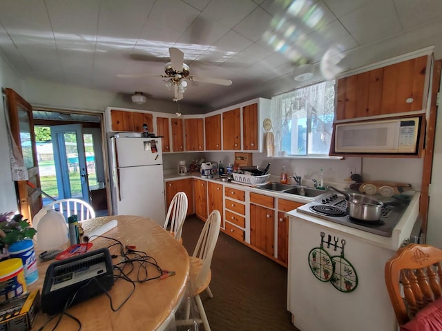 kitchen featuring white appliances, ceiling fan, and sink