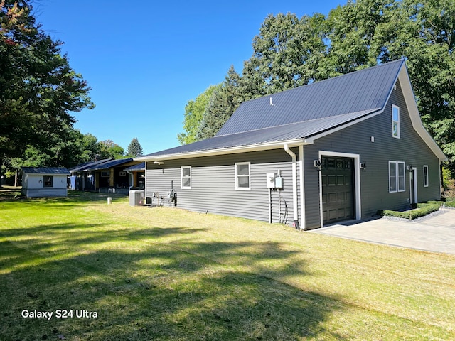 exterior space featuring central AC and a yard