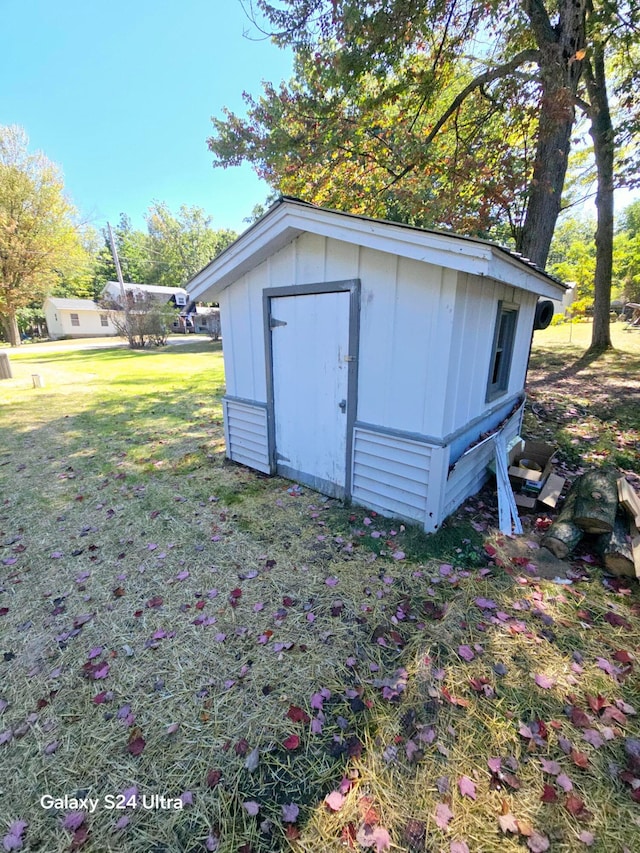 view of outbuilding featuring a yard