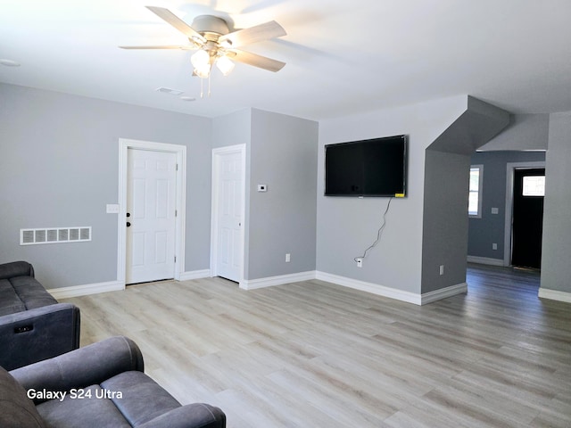 living room with ceiling fan and light wood-type flooring