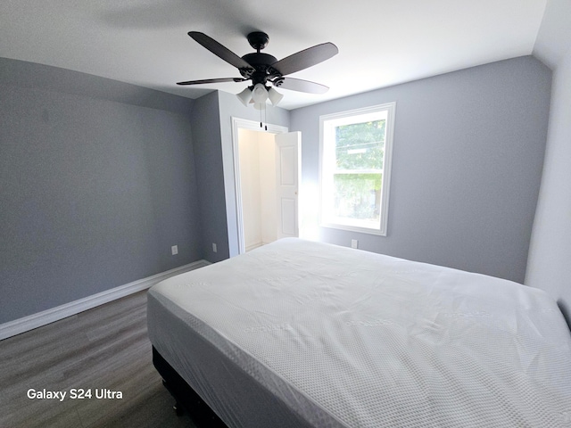 bedroom with lofted ceiling, ceiling fan, and dark wood-type flooring