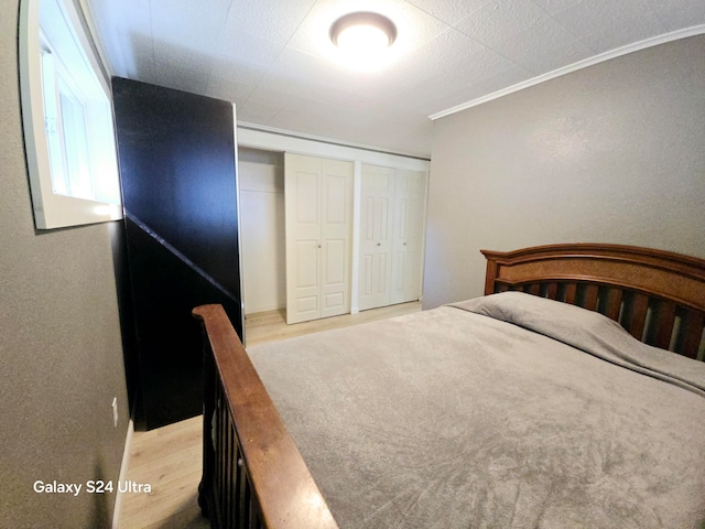 unfurnished bedroom with a closet and crown molding