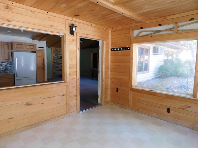 empty room with wood walls and wooden ceiling