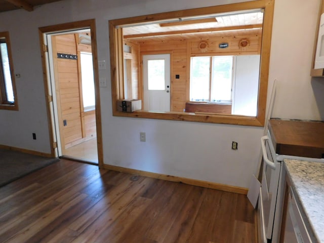 kitchen with white range oven and dark hardwood / wood-style floors