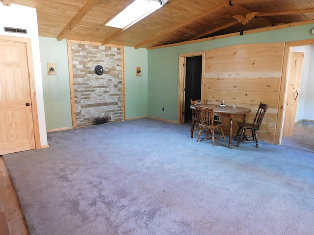 dining room featuring vaulted ceiling with beams, wood ceiling, and carpet floors