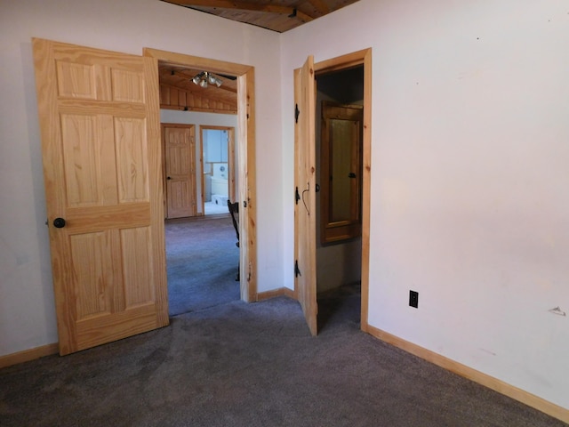 carpeted empty room with ceiling fan and wood ceiling