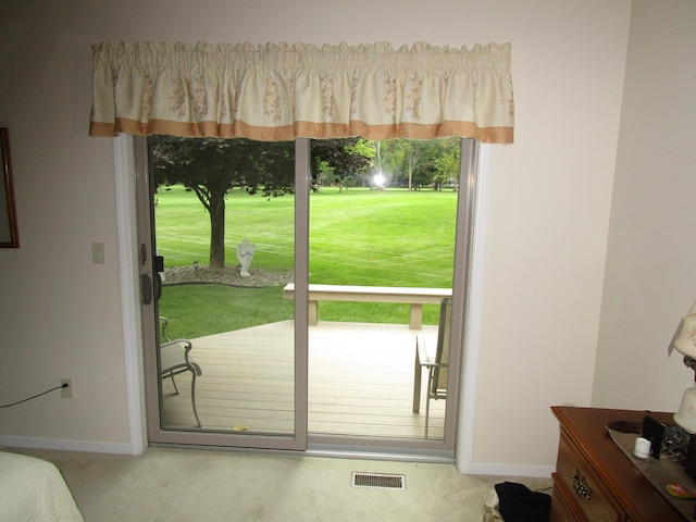 entryway featuring a wealth of natural light and carpet