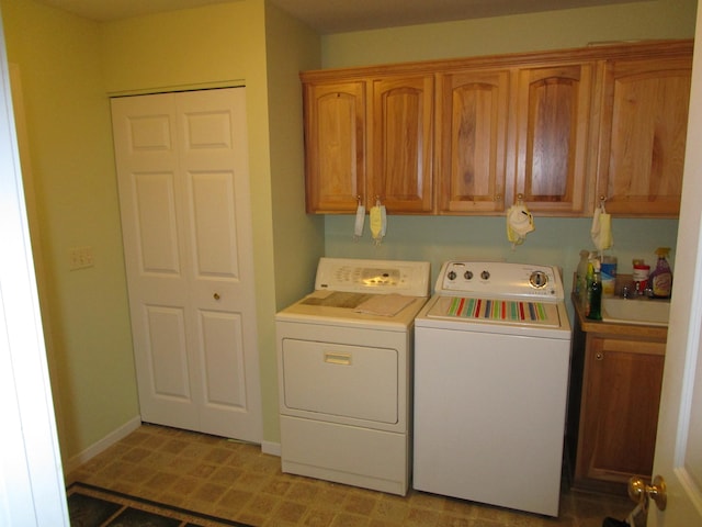 laundry area with washer and clothes dryer and cabinets