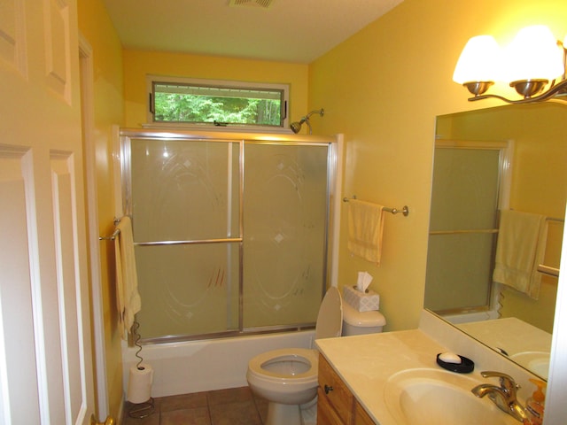 full bathroom with vanity, tile patterned flooring, enclosed tub / shower combo, and toilet