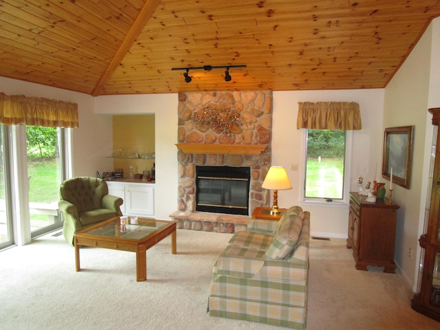 living room with vaulted ceiling, a fireplace, wooden ceiling, track lighting, and light carpet