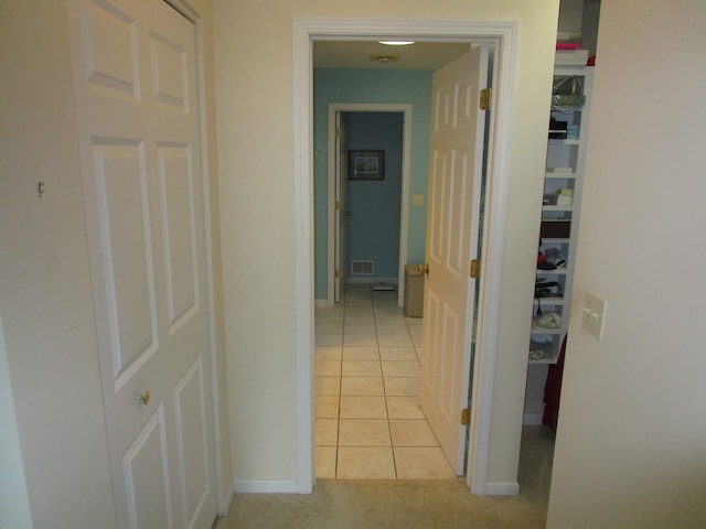 corridor with light tile patterned flooring