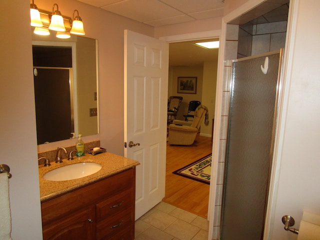 bathroom featuring vanity, hardwood / wood-style floors, and a shower with door