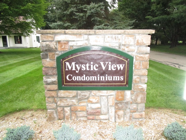 community sign featuring a lawn