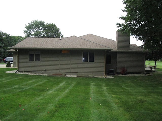 rear view of property with a yard