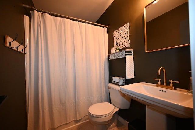 bathroom with a shower with curtain, sink, and toilet