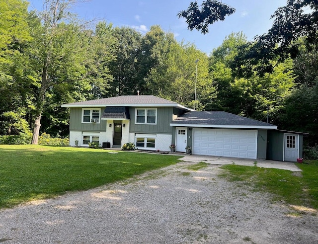 bi-level home featuring a front yard and a garage