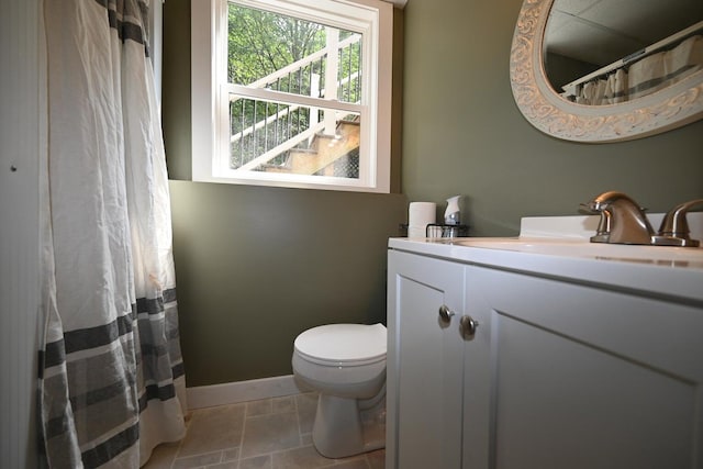 bathroom with tile patterned flooring, curtained shower, vanity, and toilet