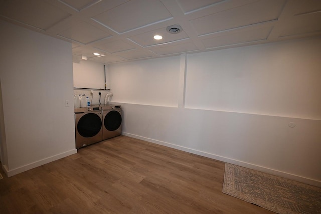 washroom with washer and clothes dryer and hardwood / wood-style flooring