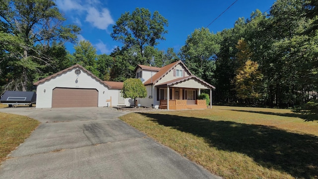 view of front of property with a front lawn, covered porch, and a garage