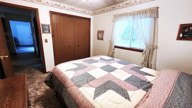 bedroom featuring a closet and dark colored carpet