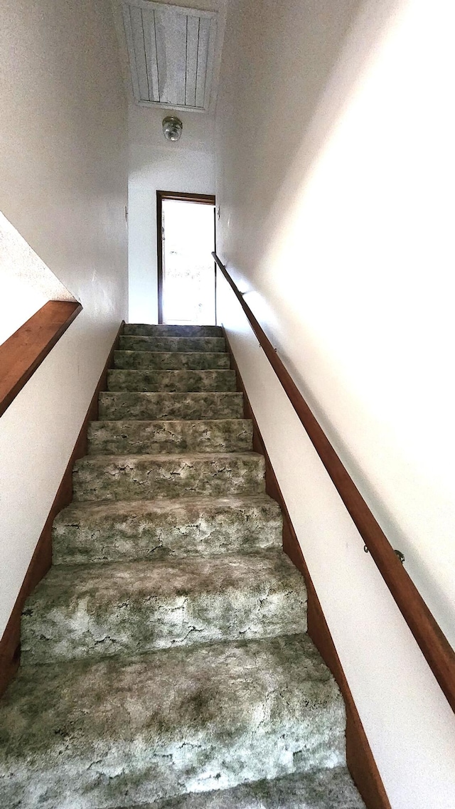 staircase featuring concrete flooring