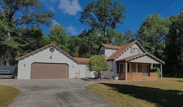 view of front of property featuring a garage, a porch, and a front lawn