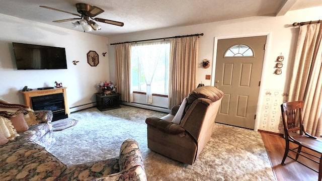 living room featuring wood-type flooring, ceiling fan, and baseboard heating