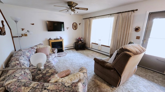 carpeted living room featuring ceiling fan and a baseboard heating unit