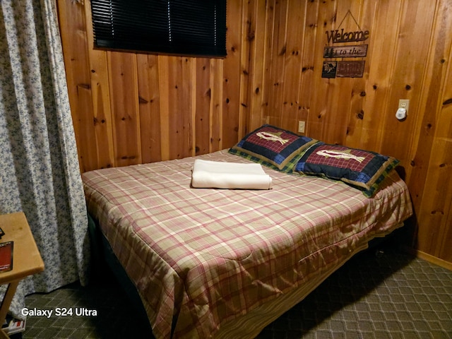 bedroom featuring wood walls