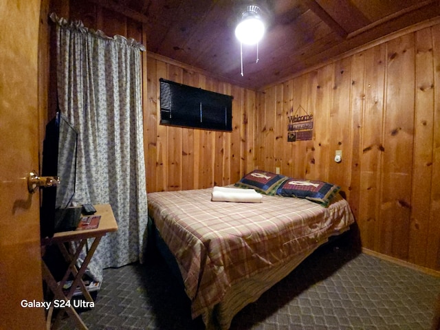 carpeted bedroom featuring wood ceiling and wood walls