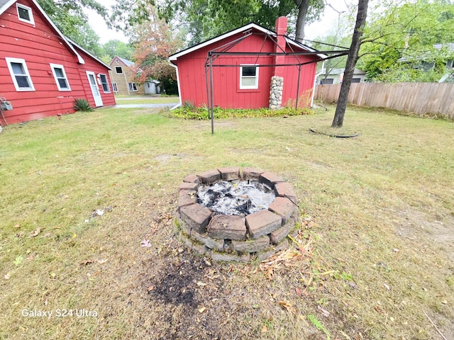 view of yard featuring a shed and a fire pit