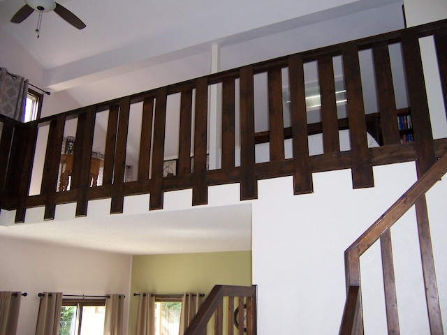 stairs featuring ceiling fan and a high ceiling