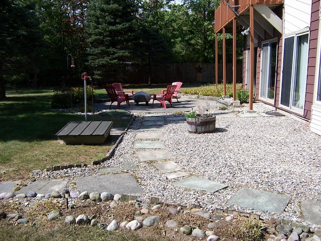 view of yard with a patio and an outdoor fire pit