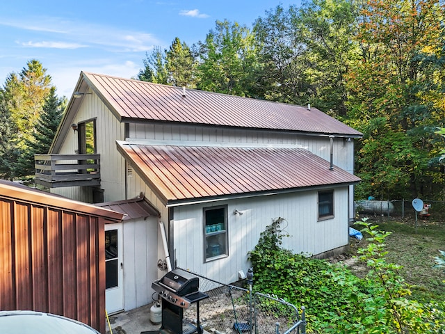 rear view of house featuring a balcony