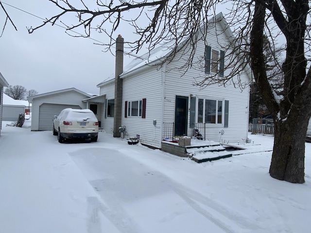 view of front of home featuring a garage and an outdoor structure