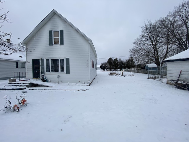 view of snow covered rear of property