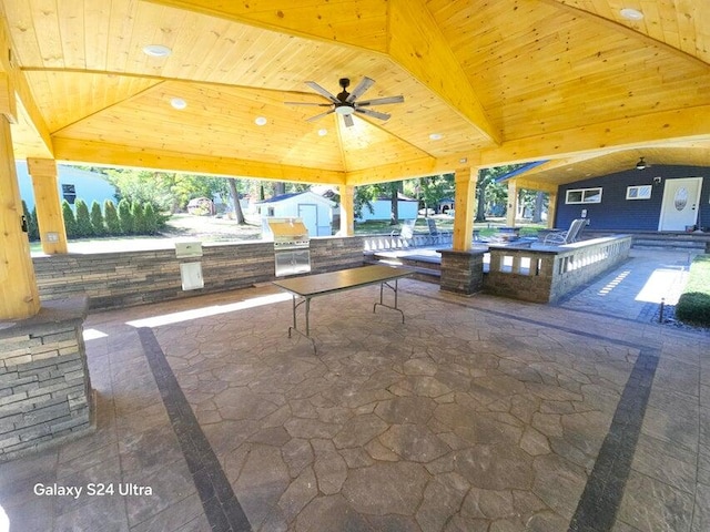 view of patio featuring area for grilling, ceiling fan, a bar, and a gazebo