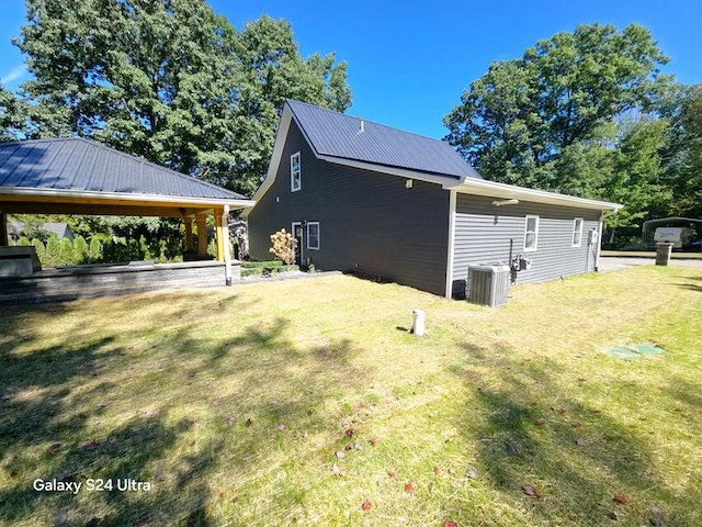 view of side of home featuring cooling unit, a gazebo, and a yard