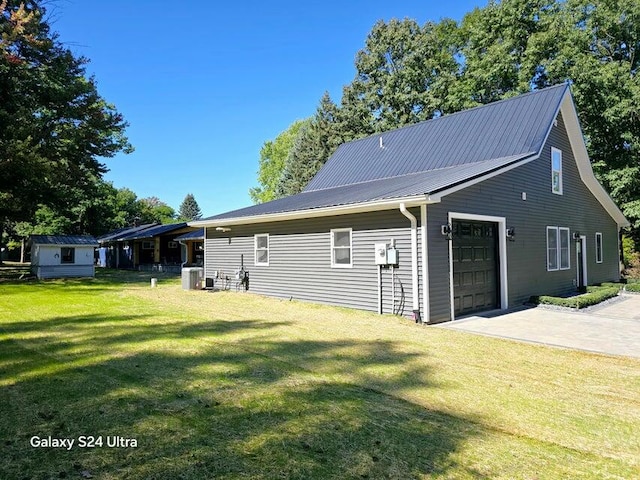 exterior space featuring a yard and central air condition unit