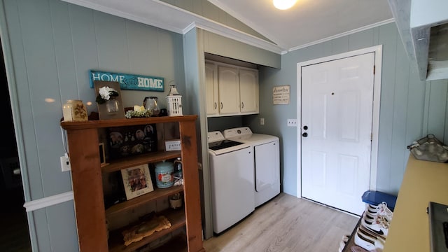 washroom featuring cabinets, light hardwood / wood-style floors, ornamental molding, and washing machine and dryer