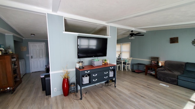 living room with vaulted ceiling with beams, ceiling fan, and hardwood / wood-style floors