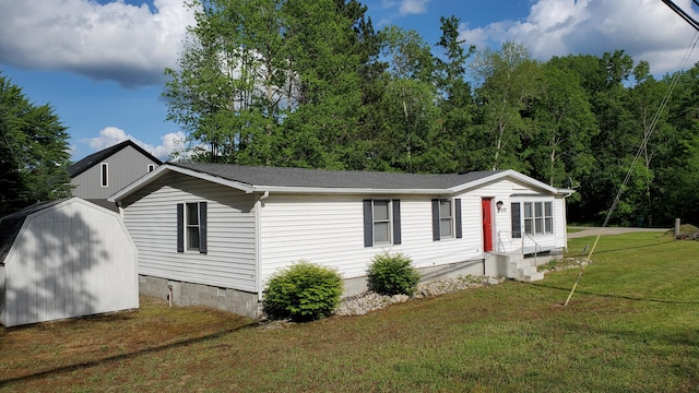 view of front facade with a front lawn and a storage unit