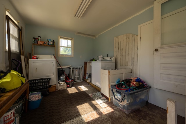 misc room with dark colored carpet, vaulted ceiling, and washing machine and clothes dryer