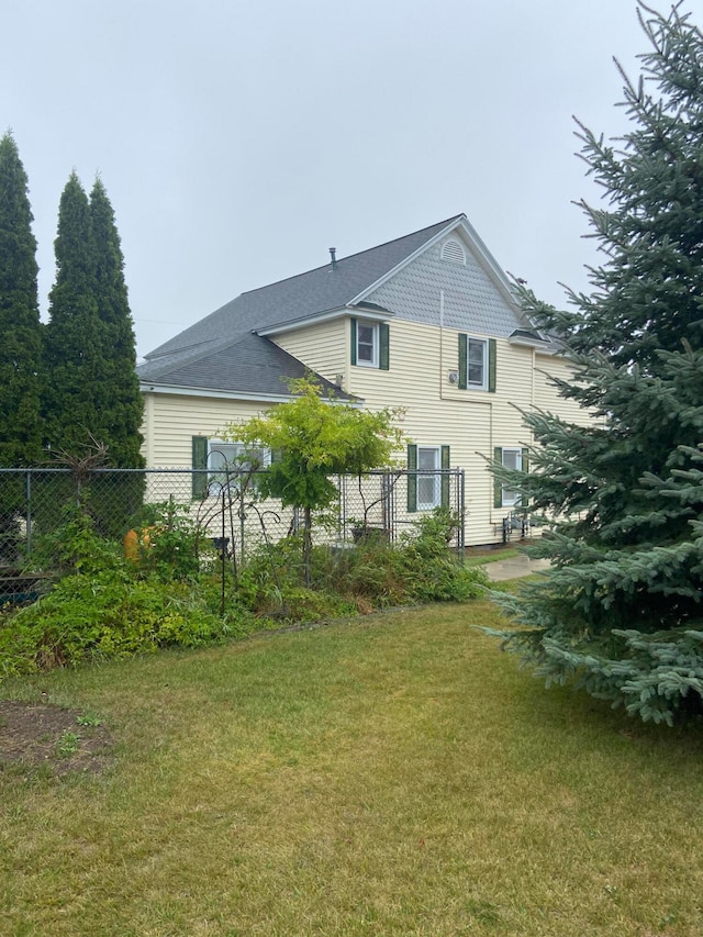 rear view of house with a lawn