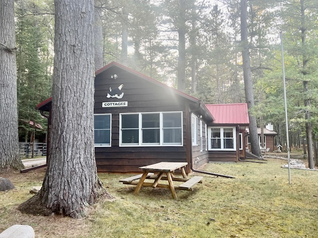 rear view of house featuring a yard